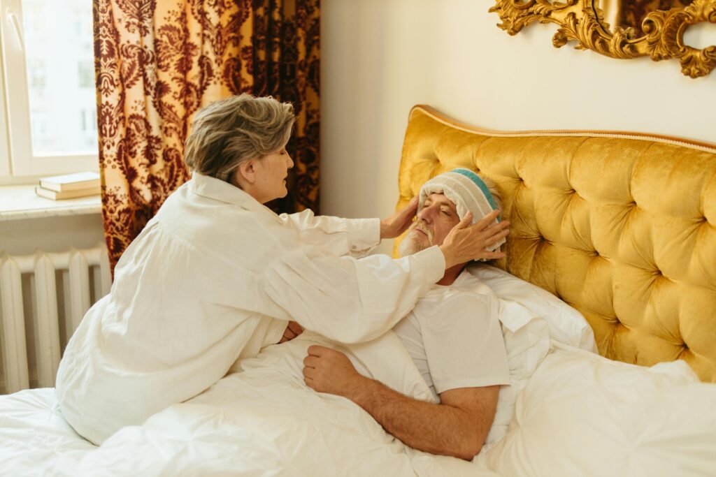 pexels-photo-8088605-8088605 A woman provides care to an unwell man in bed, showing warmth and affection.
